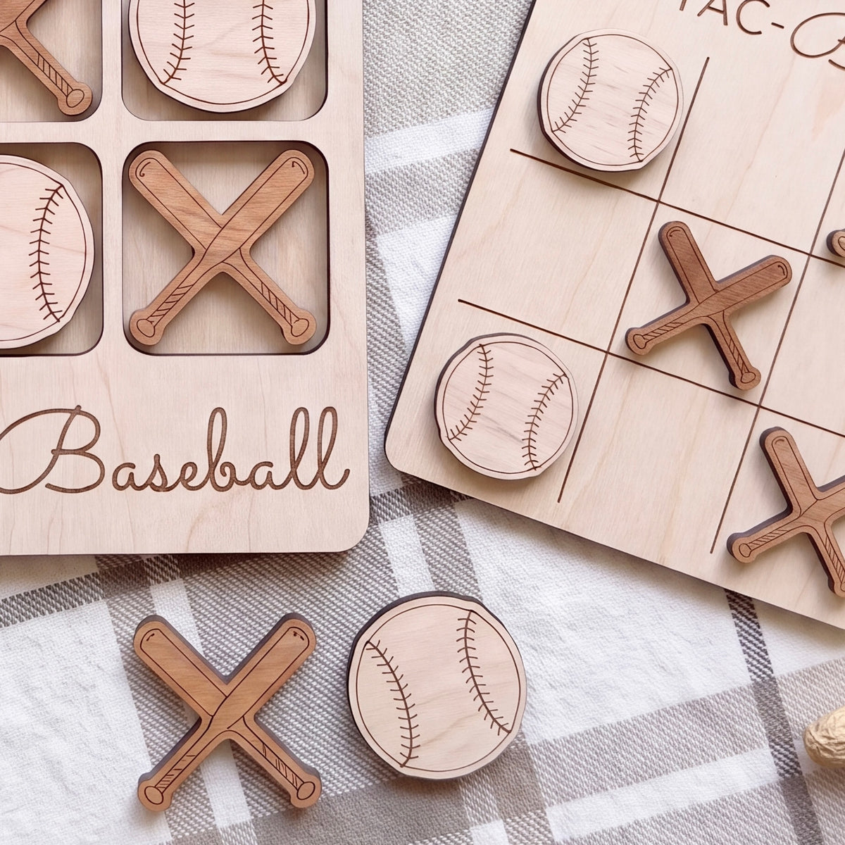 a wooden game board with baseball-themed pieces, including a tic-tac-toe board and a baseball bat and ball.