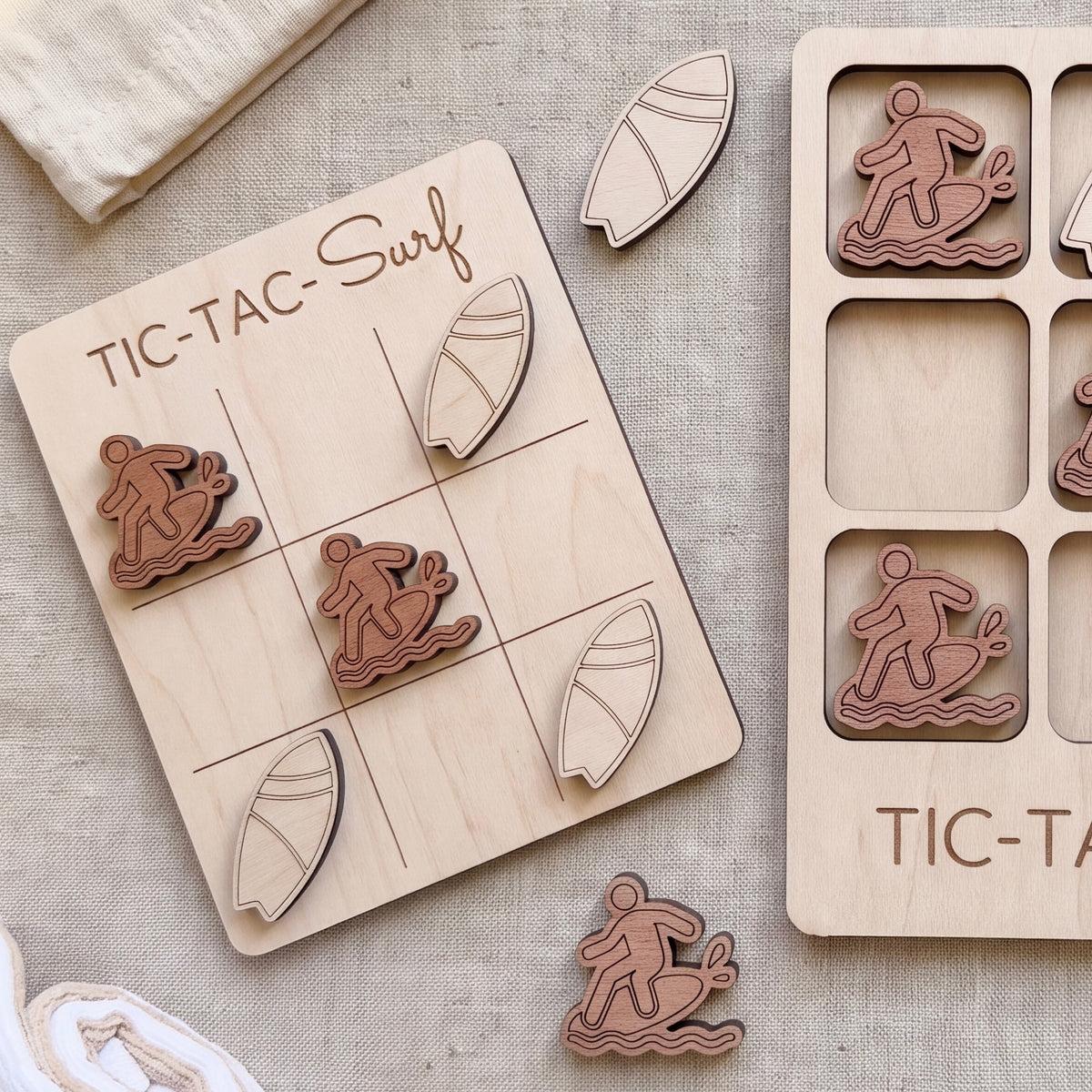a wooden tic-tac game with a surf theme, including a wooden board with a surfboard and several wooden pieces shaped like surfers.