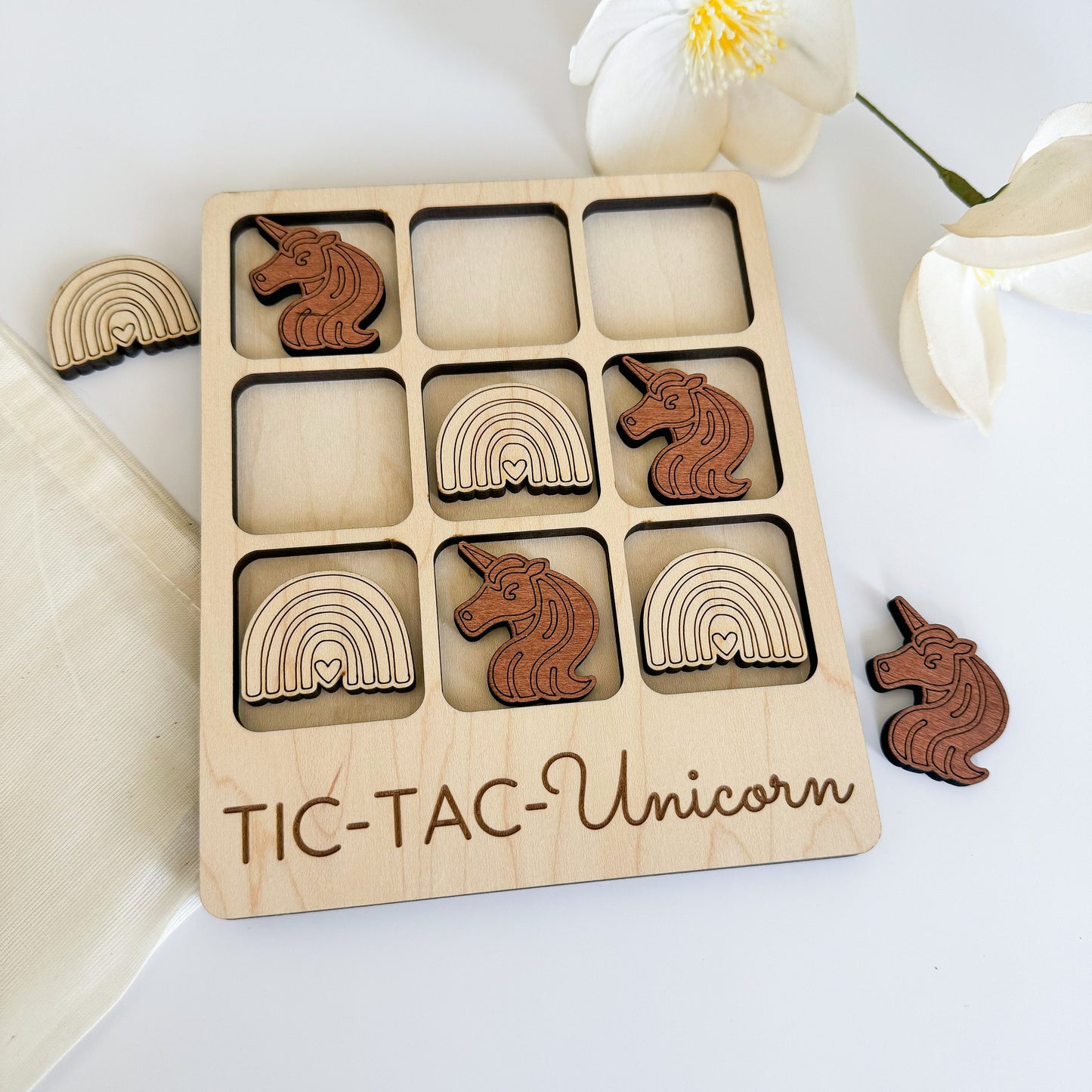 a wooden tray with wooden cutouts of animals and rainbows