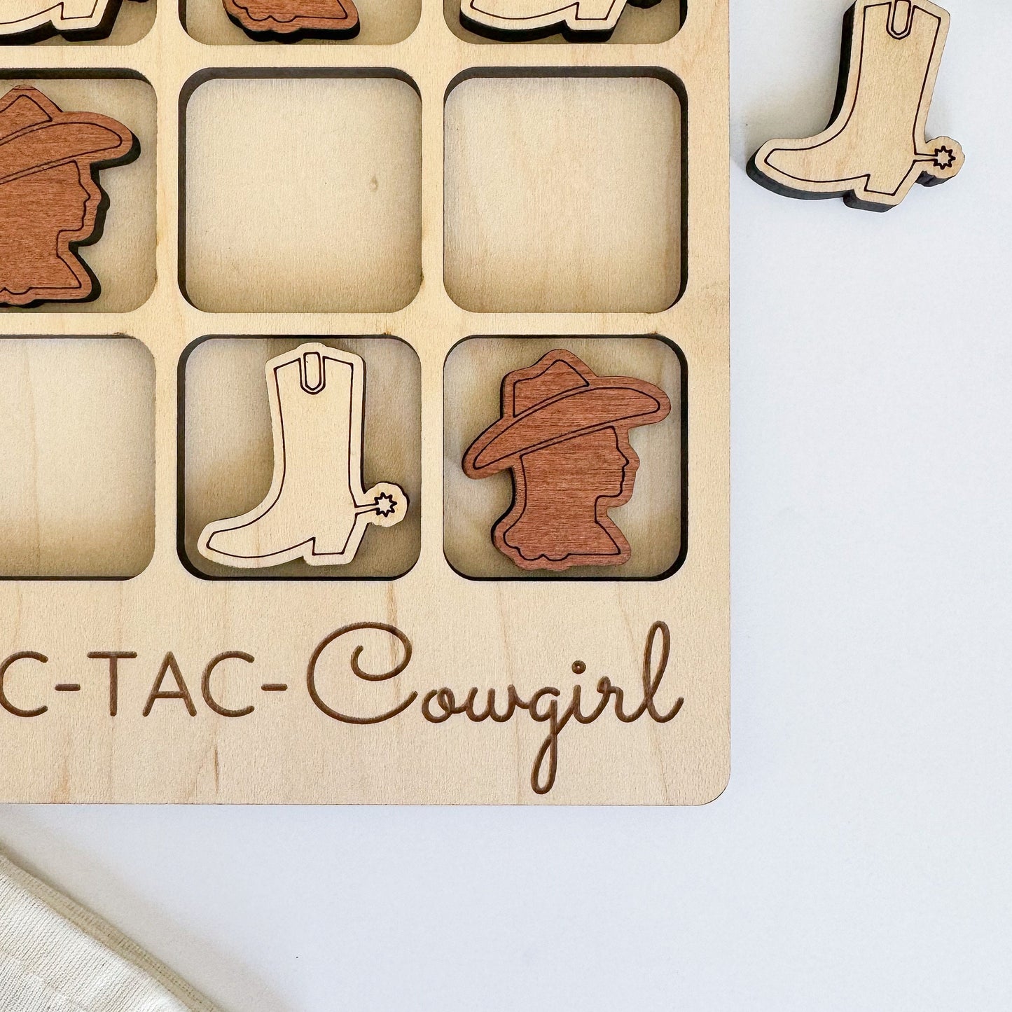 a wooden puzzle with a picture of a pair of boots and boots