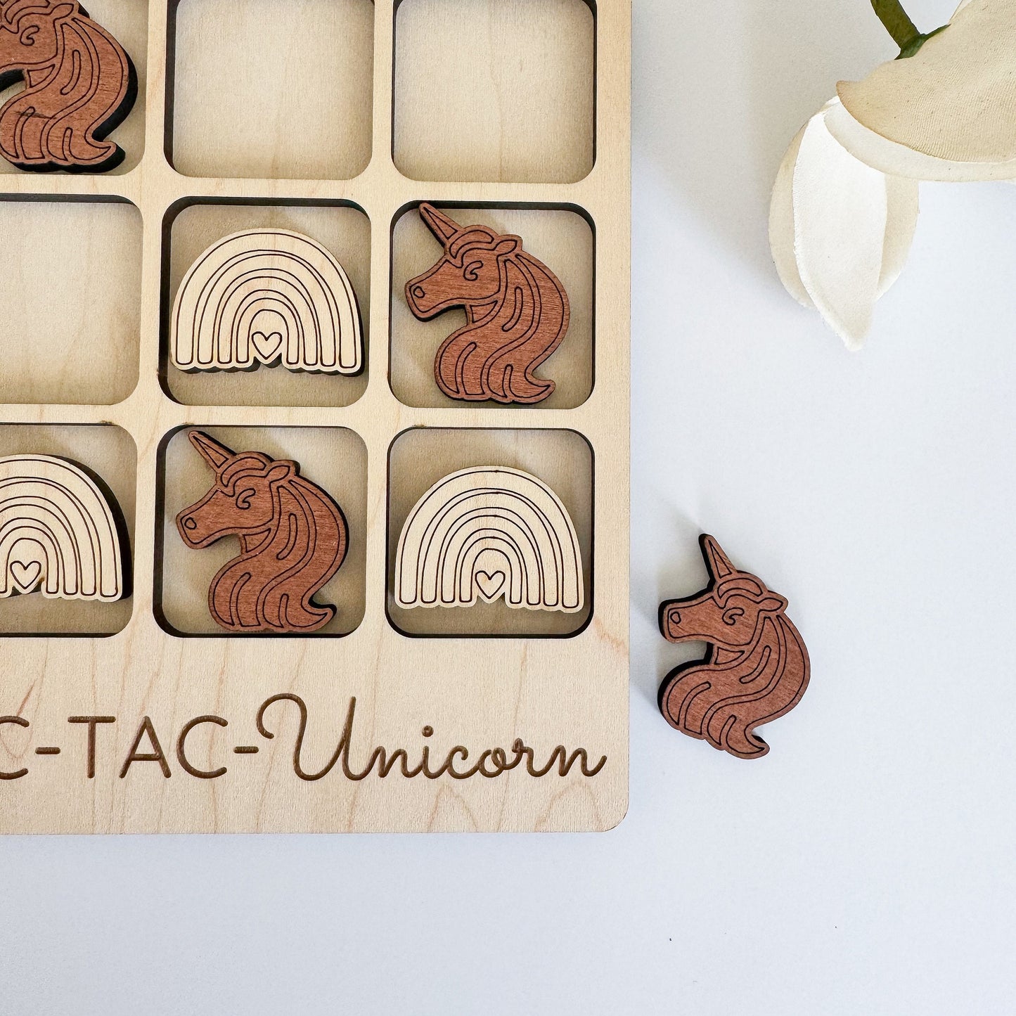 a wooden puzzle with wooden unicorns and rainbows