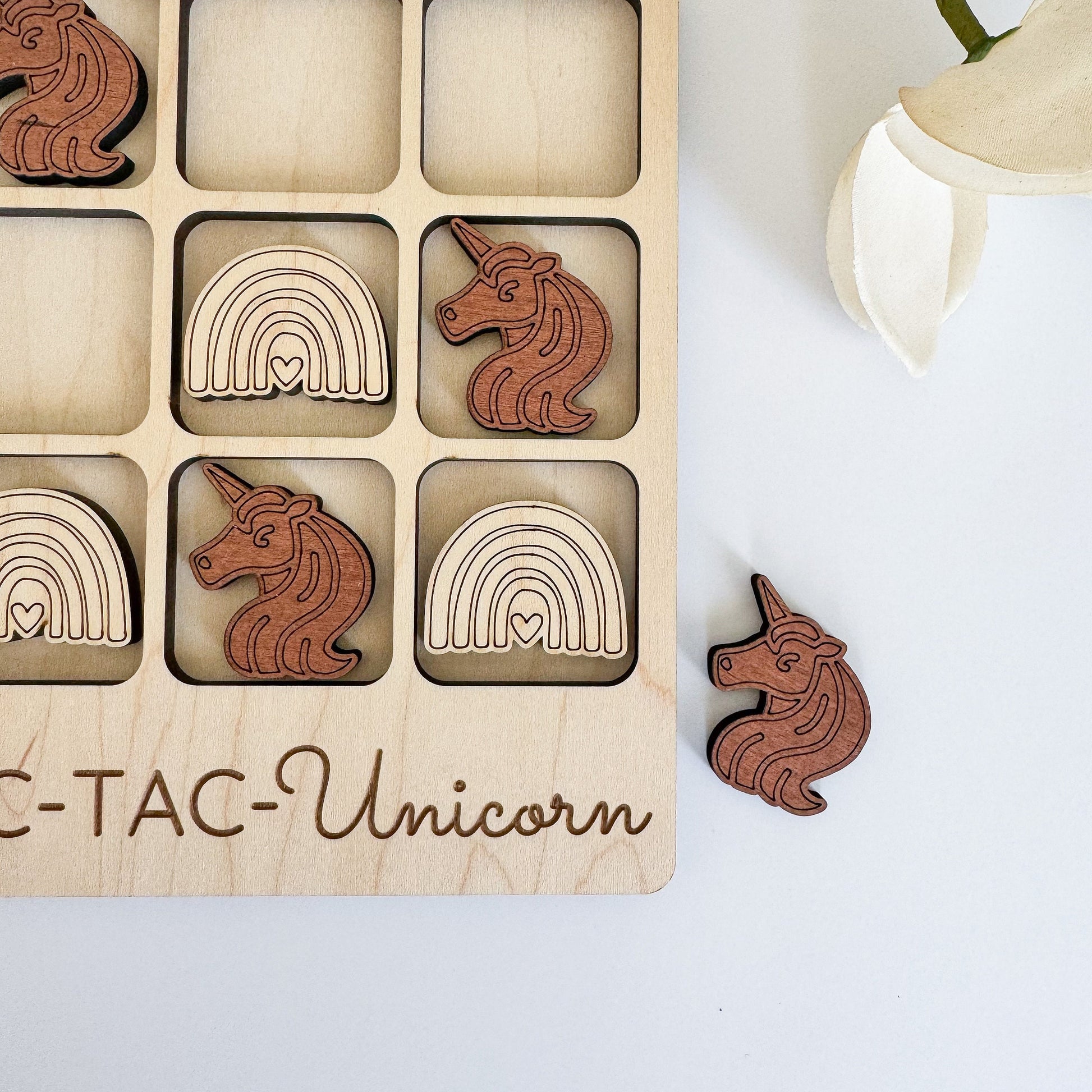 a wooden puzzle with wooden unicorns and rainbows