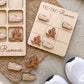 a wooden tic-tac runner game with wooden pieces shaped like runners and a wooden board with a tic-tac grid. There are also some white sneakers and a woven mat in the background.
