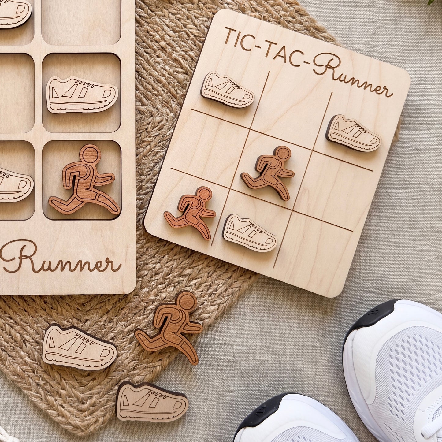 a wooden tic-tac runner game with wooden pieces shaped like runners and a wooden board with a tic-tac grid. There are also some white sneakers and a woven mat in the background.