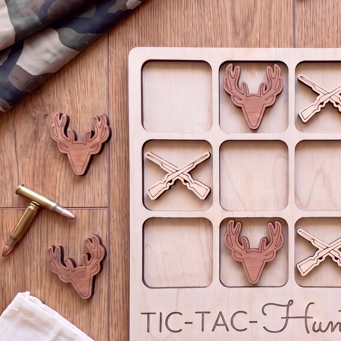 a wooden tic-tac game with deer head tiles and a bullet on a wooden surface.
