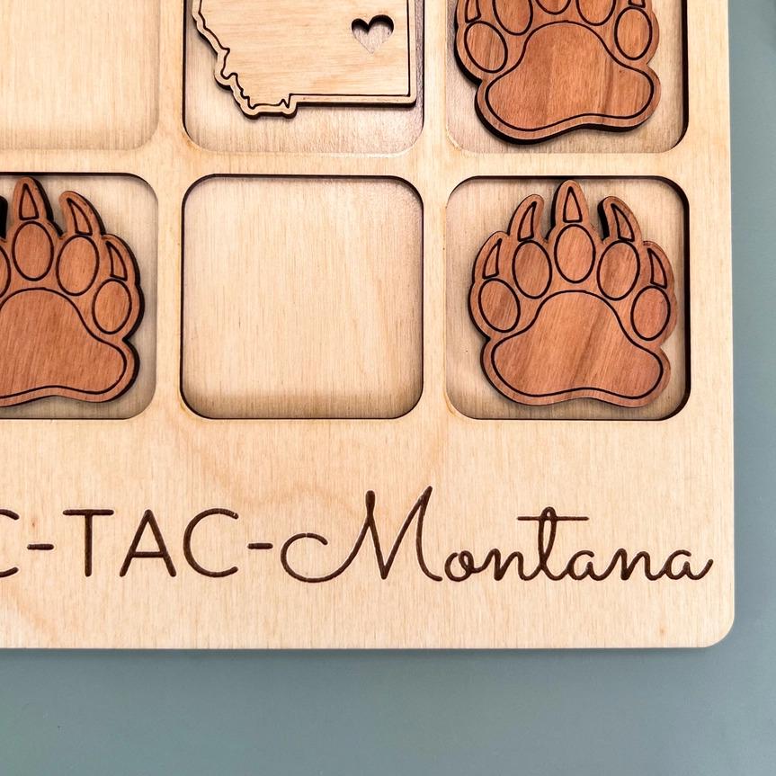 a picture of a bear paw magnet with the state of montana on it