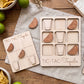 a wooden game board and wooden pieces shaped like glasses and limes, arranged on a wooden surface.