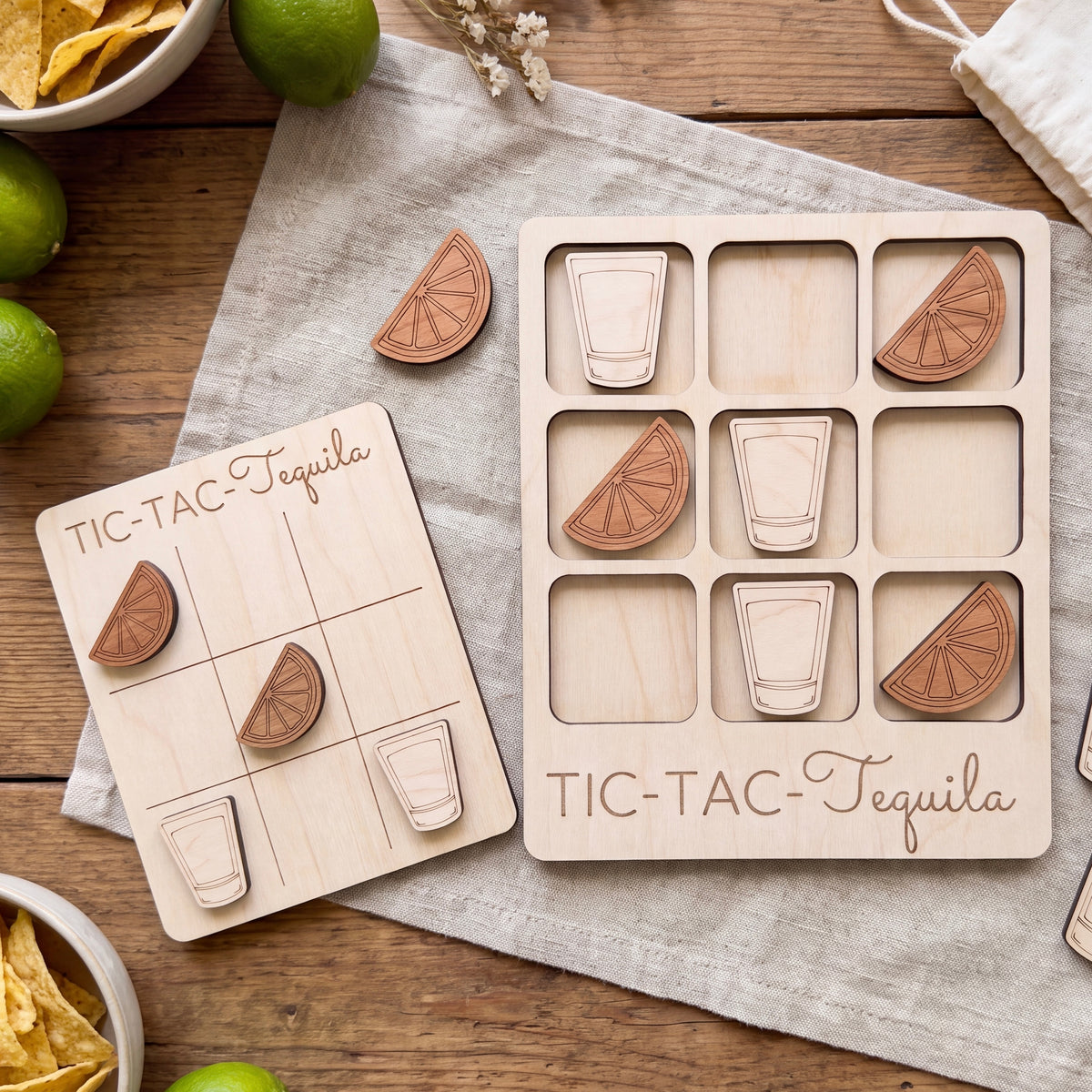 a wooden game board and wooden pieces shaped like glasses and limes, arranged on a wooden surface.