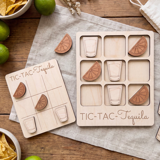 a wooden game board and wooden pieces shaped like glasses and limes, arranged on a wooden surface.