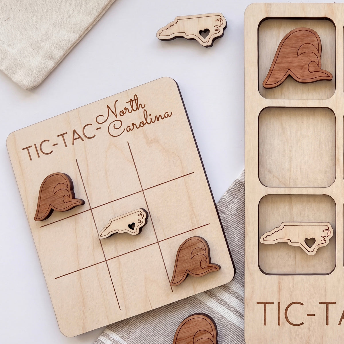 a wooden tic-tac game board with wooden tic-tac pieces, and a wooden tic-tac card with wooden tic-tac pieces.