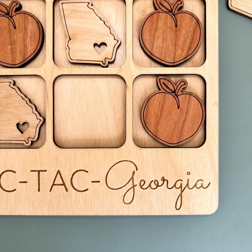 a wooden puzzle with a state of georgia surrounded by wooden cutouts