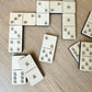 a collection of wooden dominoes arranged on a wooden surface.