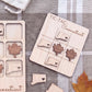 a wooden tic-tac game board with a Connecticut theme, including wooden leaves and state shapes, as well as a small wooden leaf on a gray cloth.