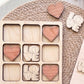 a wooden tic-tac-toe board with the word "LOVE" written on it, along with several wooden heart-shaped cutouts.