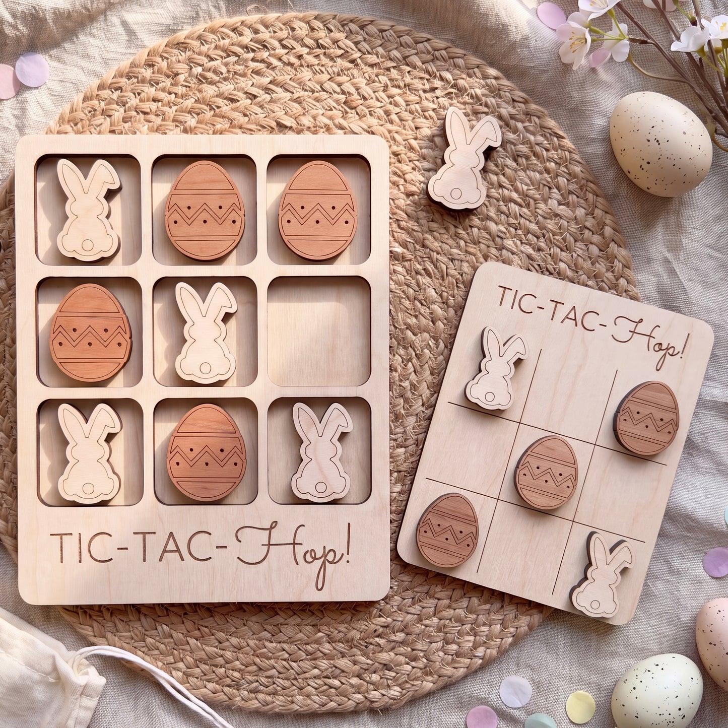 a wooden Easter-themed game with wooden Easter eggs and wooden bunnies, arranged on a woven placemat.