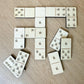 a collection of wooden dominoes arranged on a wooden surface.