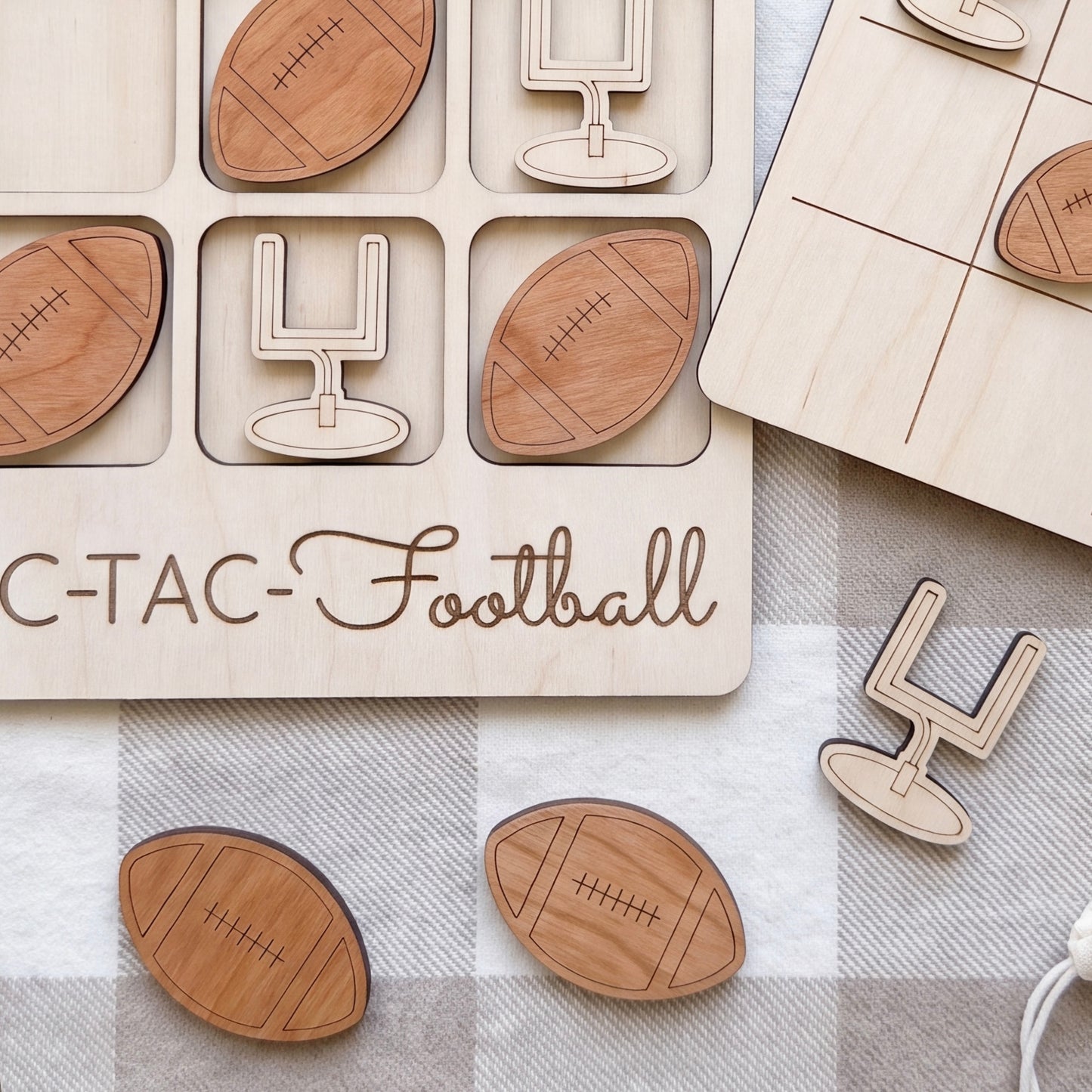 a wooden tic-tac game with football-themed pieces, including a tic-tac board and various football-shaped tiles.