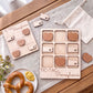 a wooden Tic-Tac game board with wooden hearts on it, along with a plate of pretzels and a white cloth.
