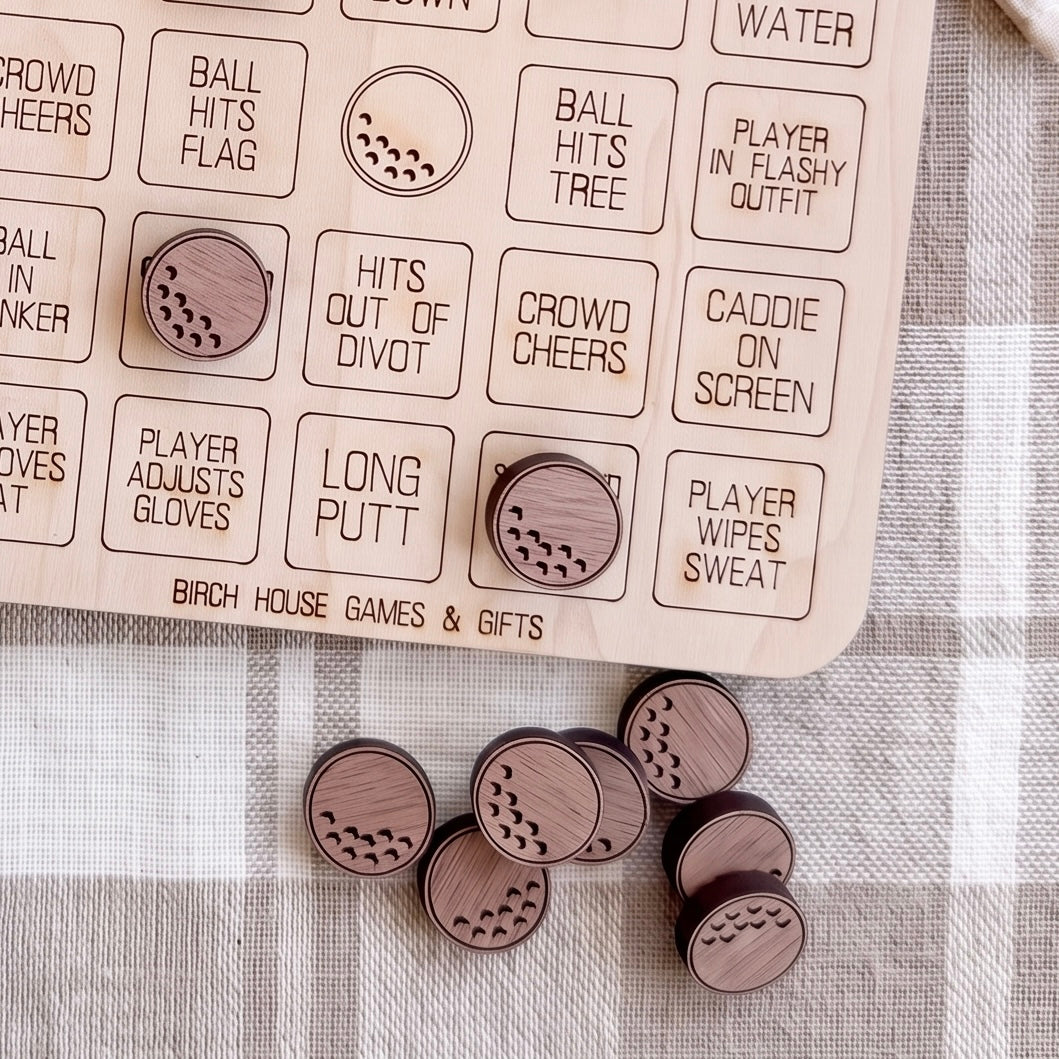 a wooden board game with various labels and a collection of wooden golf-themed game pieces on a table.