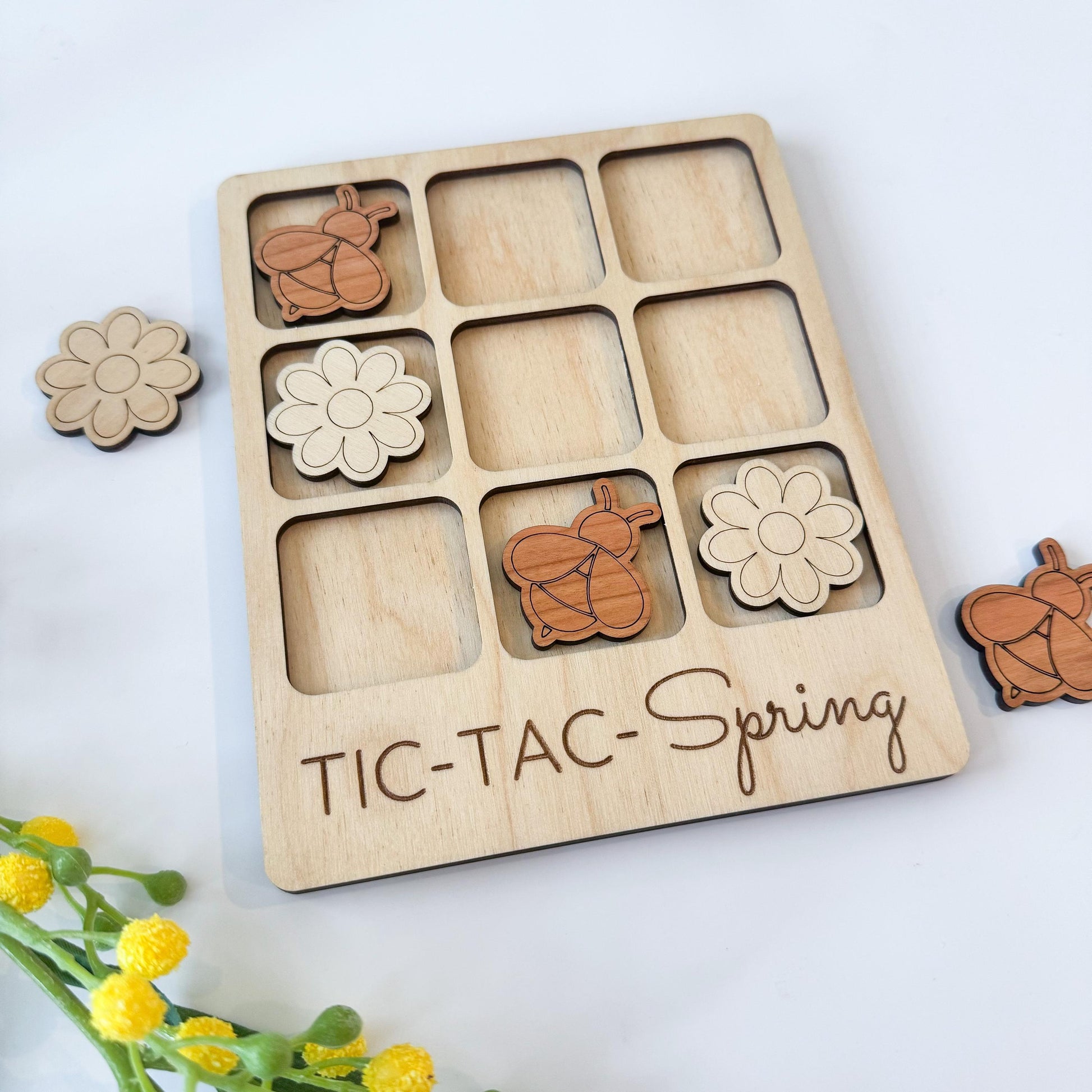 a wooden tic - tac - spring game with flowers and teddy bears
