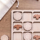 A wooden tic-tac game with wooden pieces in the shape of birds, arranged in a grid on a wooden surface.