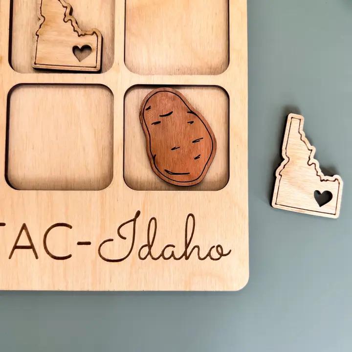 a wooden magnet with a picture of a potato and a heart