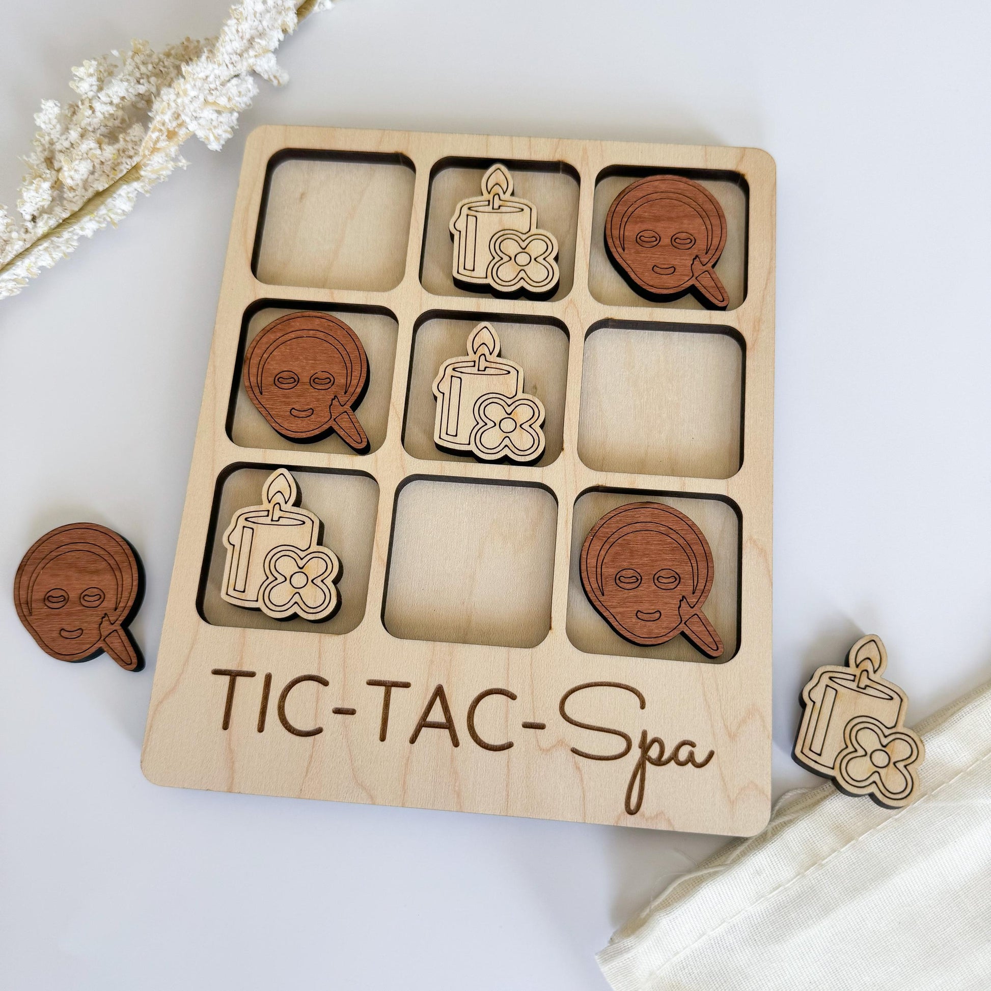 a wooden tic - tac - spa game with wooden pieces
