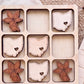 a wooden board with nine cut-out shapes, each representing a different state in the United States. The shapes are arranged in a 3x3 grid, with each state having its own unique design.