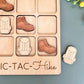 a wooden puzzle with a picture of a pair of shoes and a pair of boots