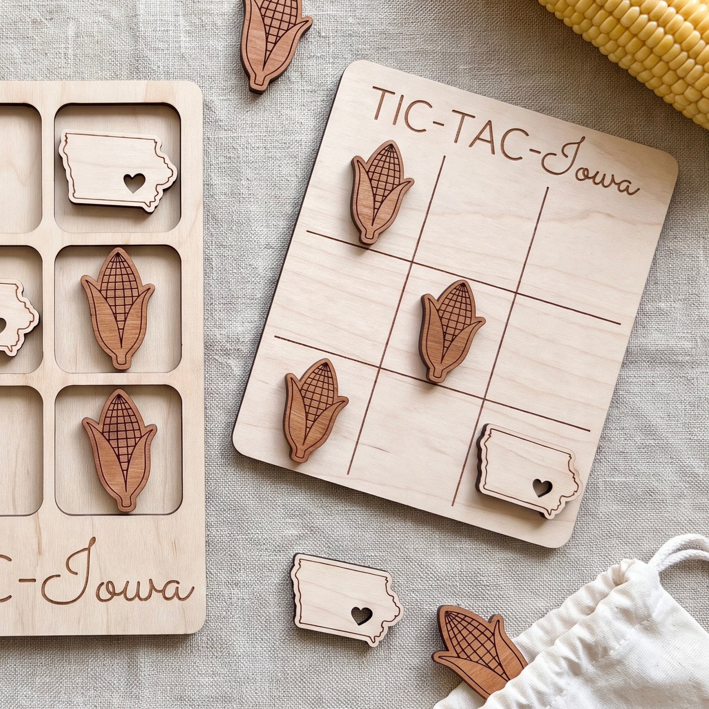 a wooden tic-tac game with wooden cornucopia pieces and a wooden sign that says "TIC-TAC-IOWA".