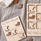 a wooden tic-tac game with Minnesota state shapes as game pieces, and a wooden tic-tac game board with Minnesota state shapes as game pieces.