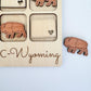 a wooden puzzle with elephants and a heart