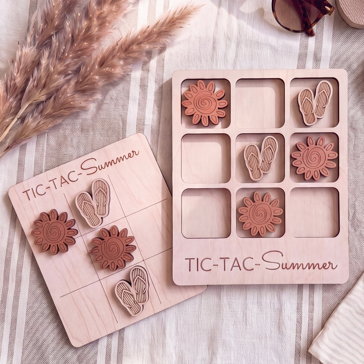 a wooden game board and a wooden tile with a pattern of sunflowers and flip-flops, both labeled "TIC-TAC Summer".