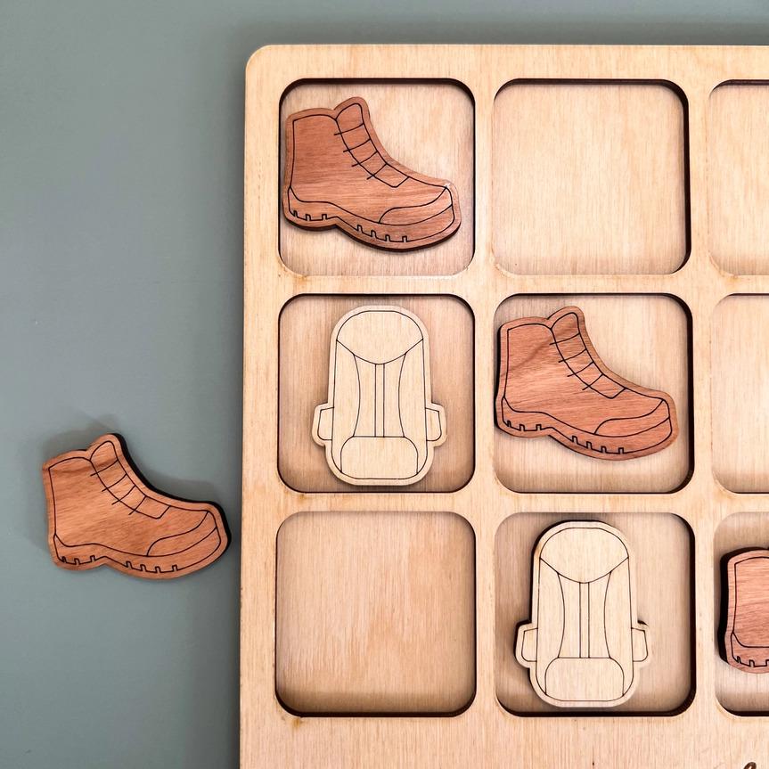 a wooden puzzle with a pair of shoes on it