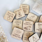 a bunch of wooden magnets with words on them