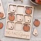 A wooden tic-tac game board with wooden pieces shaped like states and apples, labeled "TIC-TAC-Georgia".