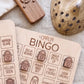 a wooden bingo board with the word "HORROR" written on it, along with various game elements such as a wooden remote control and a wooden object with holes.