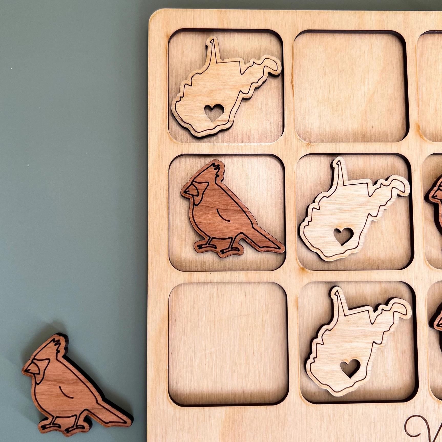 a wooden puzzle with a couple of birds on it