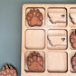 a wooden puzzle with a picture of a bear's paw