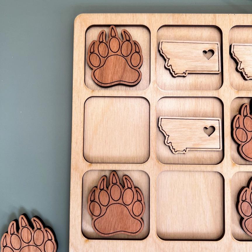 a wooden puzzle with a picture of a bear's paw