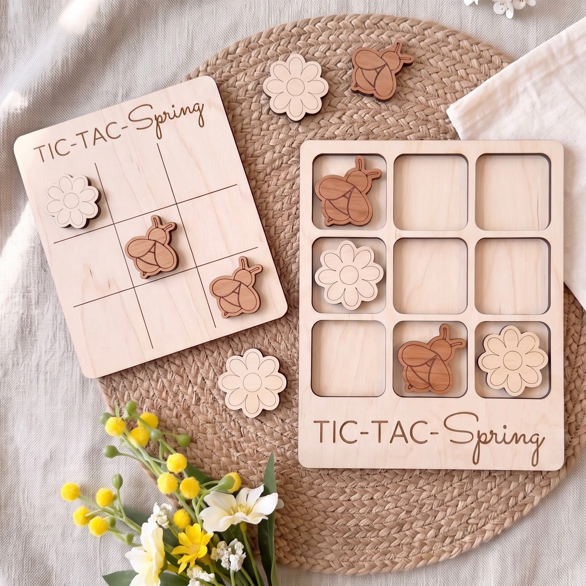 a wooden tic-tac game with a spring theme, along with some wooden shapes and flowers.