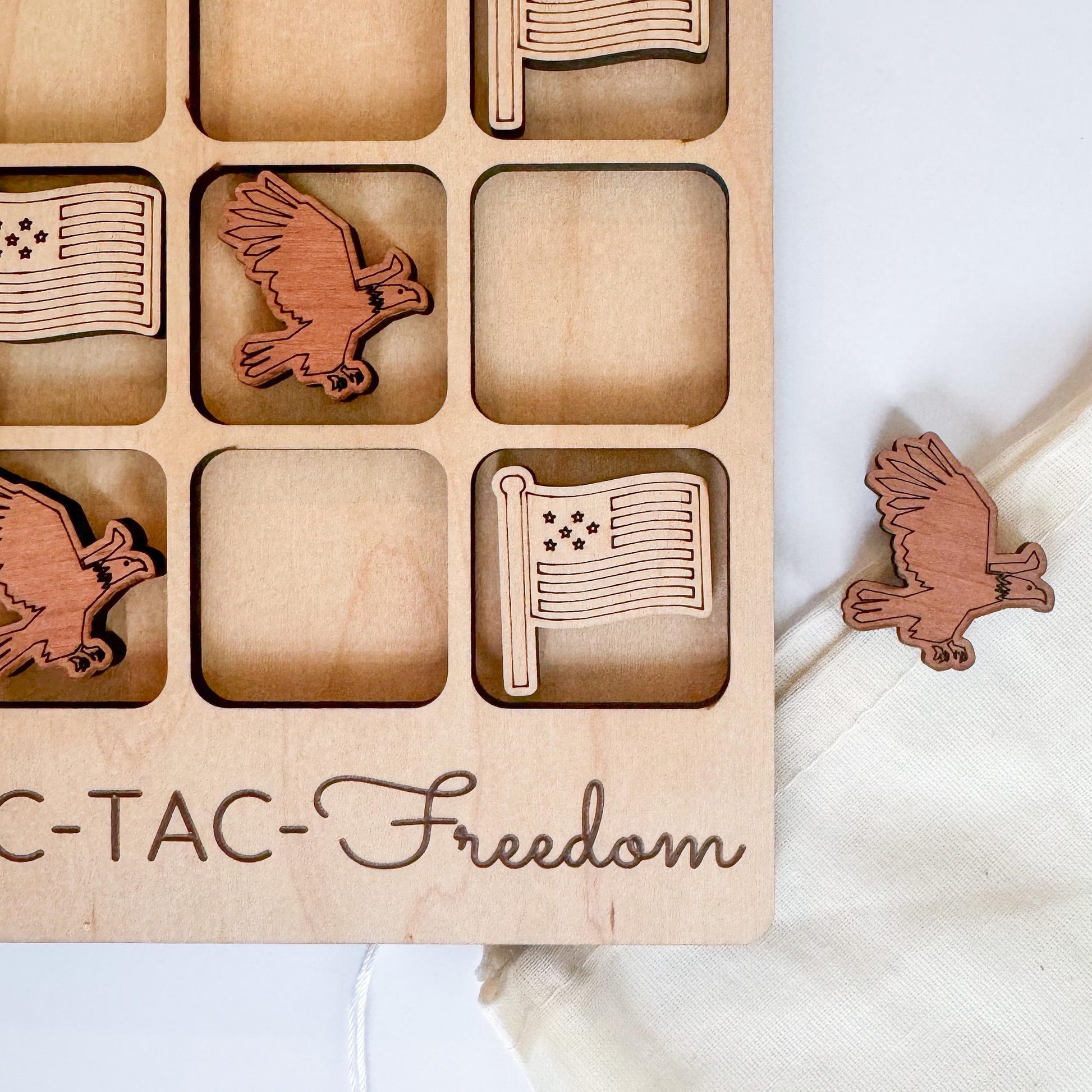 a wooden tray with wooden cutouts of flags and a bird