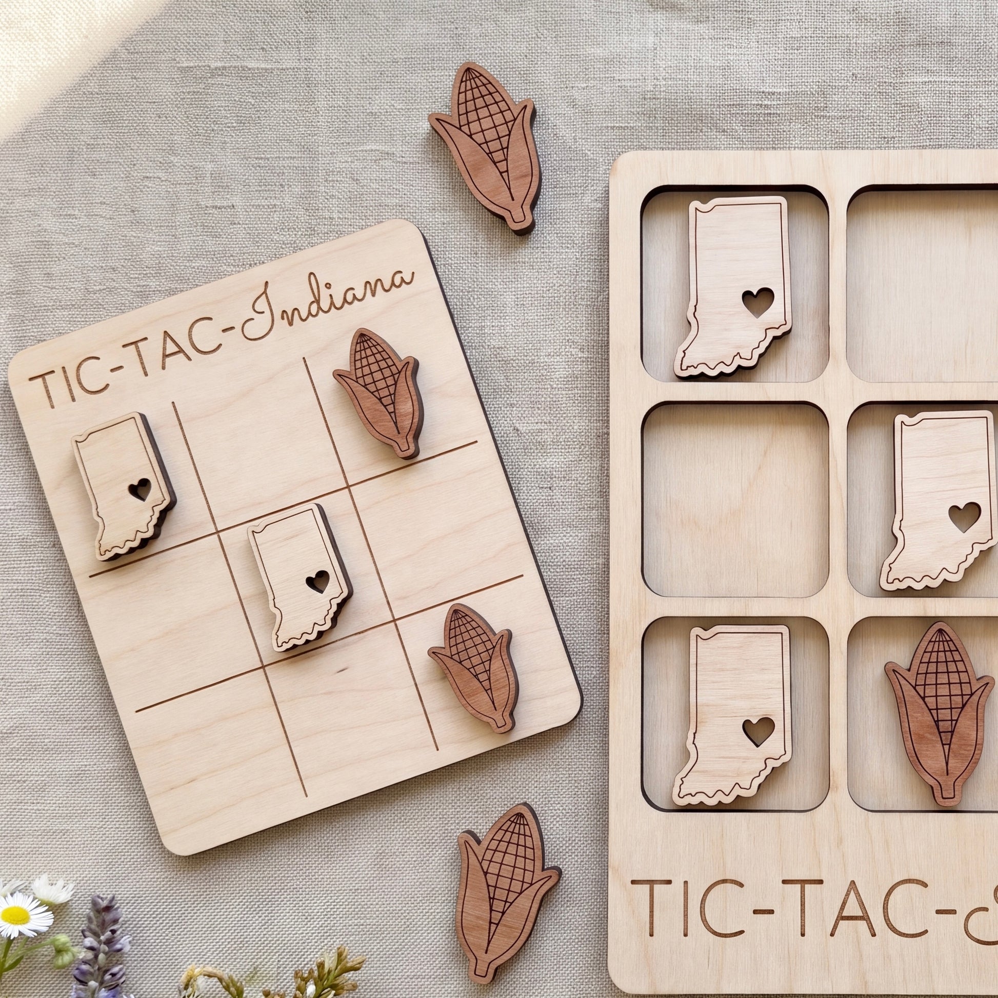 a wooden tic-tac game with a light wood texture and a light wood border. The game board is decorated with wooden cornucopia cutouts in the shape of the states of the United States, including Indiana. The game pieces are also made of wood and are placed on the game board.