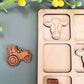 a wooden puzzle with a tractor and a cow on it