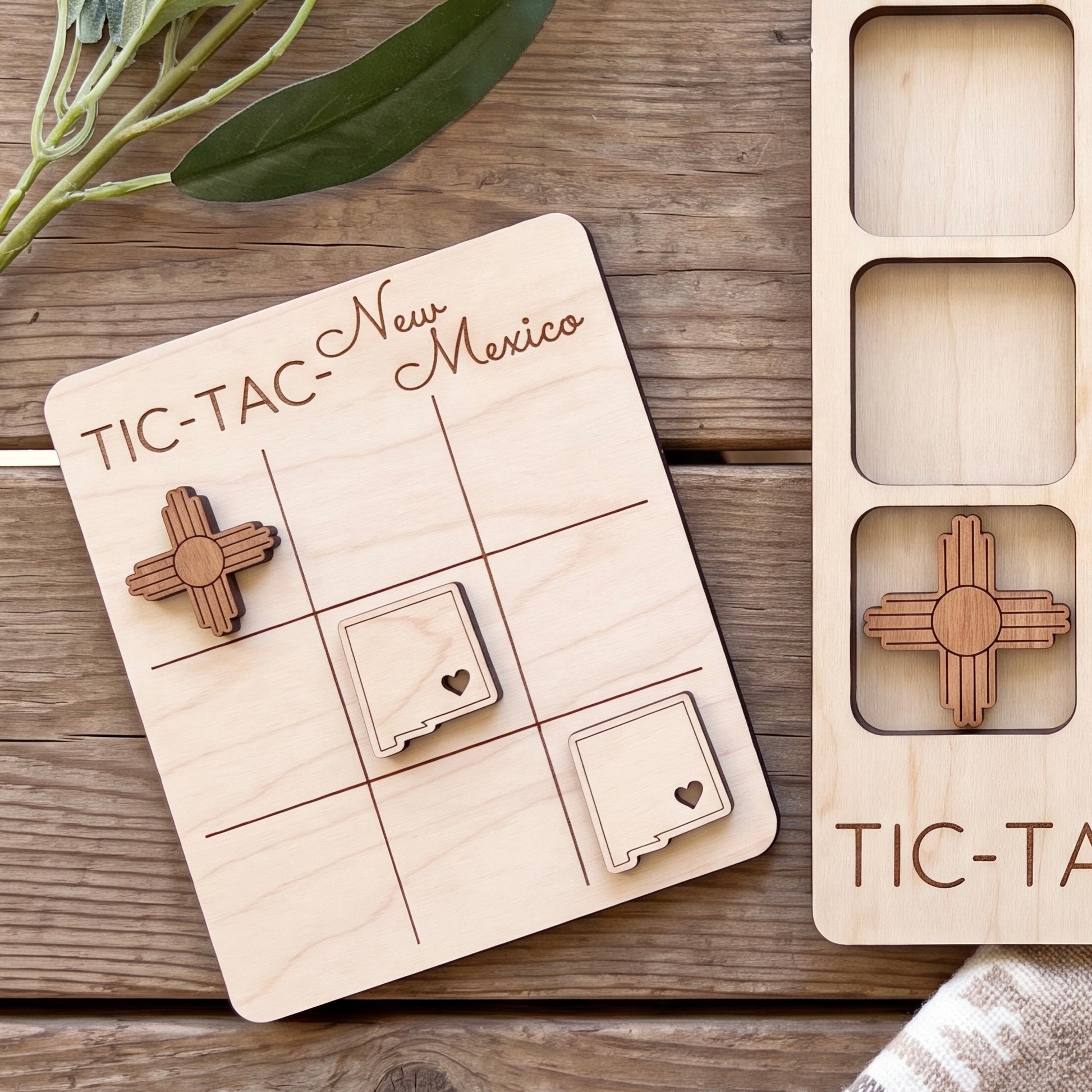 a wooden game board with a tic-tac game and two wooden pieces shaped like states of the United States.