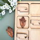 a close up of a wooden object with flowers in the background