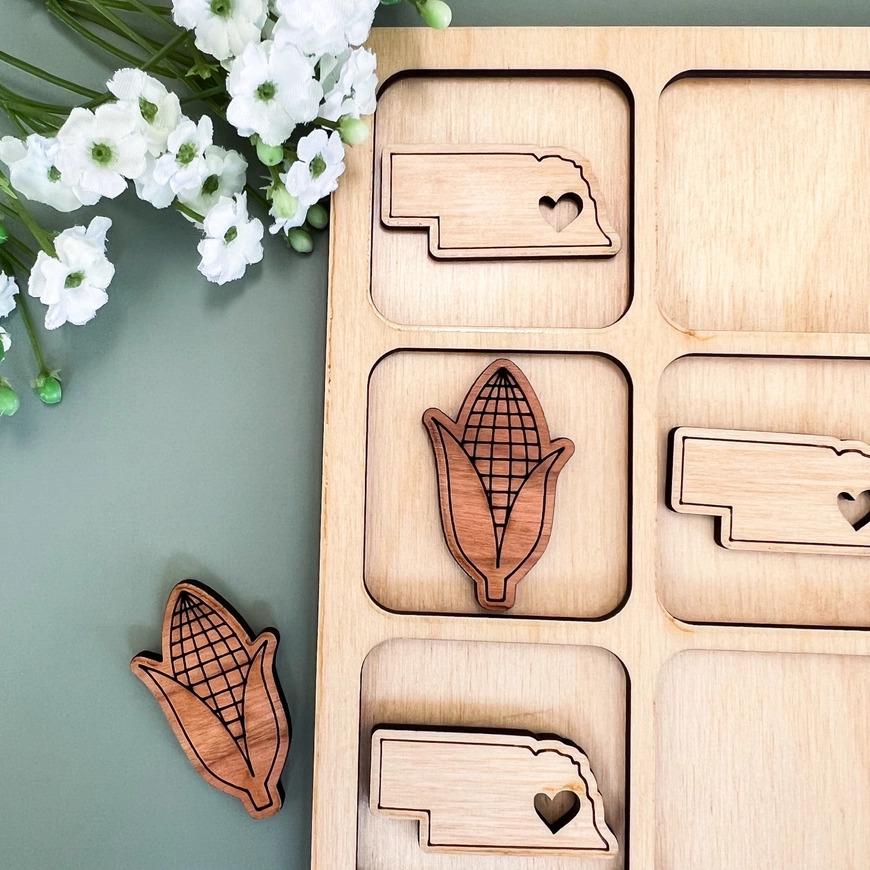 a close up of a wooden object with flowers in the background