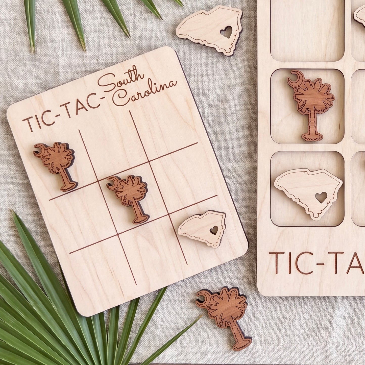 a wooden tic-tac game with a South Carolina theme, including a wooden tic-tac board and various wooden pieces shaped like states in South Carolina.