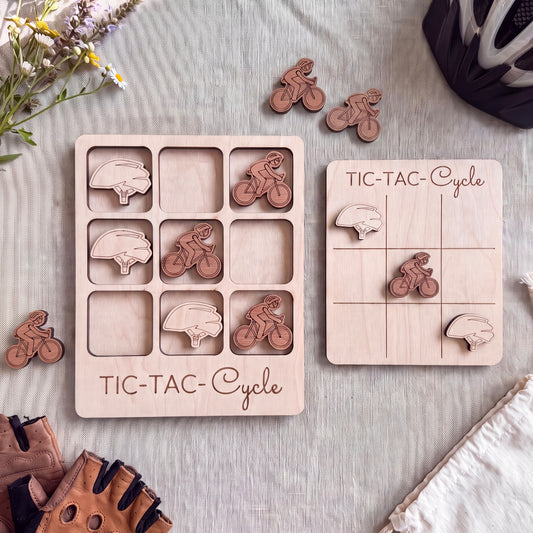a wooden tic-tac game board and a set of wooden bicycle-themed game pieces, all arranged on a table.