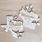 two wooden puzzle pieces shaped like the states of Texas and Wisconsin, with the words "Texas" and "Wisconsin" written on them.